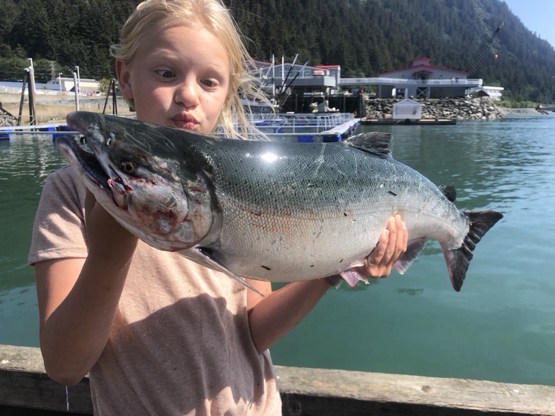 Courtney Skinner with a big chrome silver salmon at the Juneau harbor